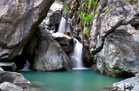 The green water between the waterfalls of Lanterna creekの写真素材