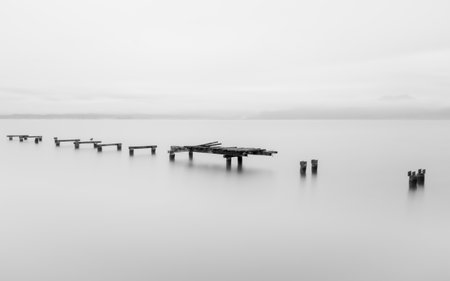 Wooden pier in a foggy morning. Black and white.の写真素材