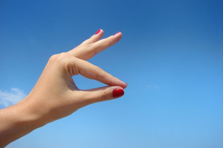 Woman gesturing with her hand holding an imaginary thing.        の写真素材