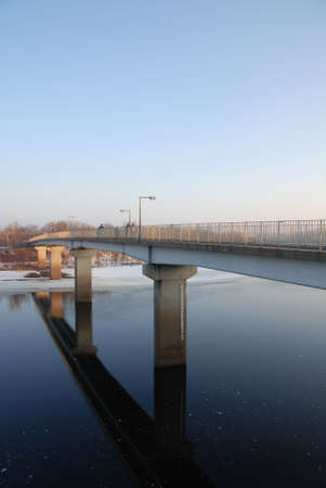 Students cross bridge on a cold spring day in Eau Claire, Wisconsin. Students cross bridge on a cold spring day in Eau Claire, Wisconsin.