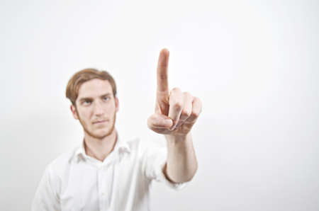 Young Adult Male in White Shirt Pointing with His Finger