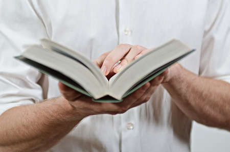 Young Adult Man's Hands Close-Up, Reading a Bookの写真素材