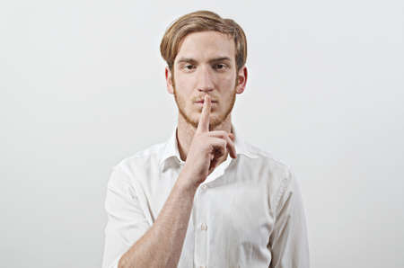 Be Quiet - Young Adult Male in White Shirt Gestures
