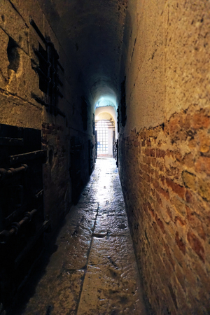 Venice, Veneto / Italy - March 2018: A dark, narrow hallway leading through the prison tunnels below the Doge's Palace in St Mark's Square, Venice, Italy.のeditorial素材