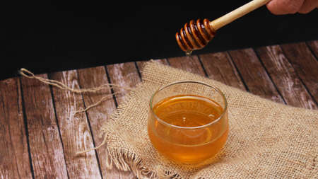 Honey is nutritious for health, stirring with a honey spoonの写真素材