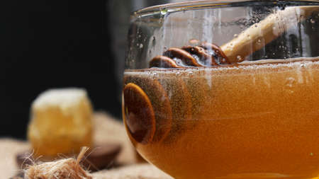 Honey is nutritious for health, stirring with a honey spoon and honeycombの写真素材