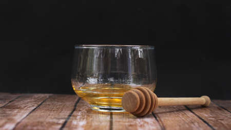 Empty glass with honey spoonの写真素材