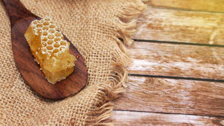 Honey is nutritious for health, stirring with a honey spoon and honeycombの写真素材