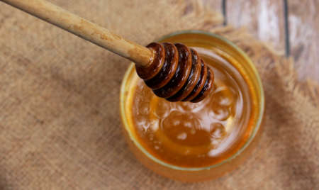 Honey is nutritious for health, stirring with a honey spoon and honeycomb