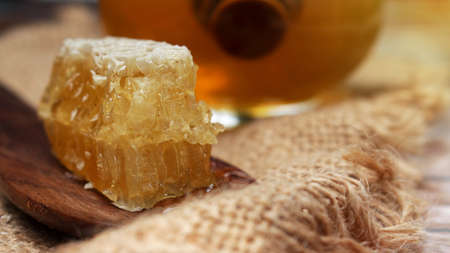 Honey is nutritious for health, stirring with a honey spoon and honeycomb