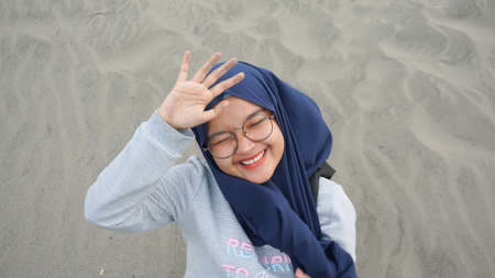Asian hijab girl is playing swing in the desert, Gumuk Pasir, Yogyakartaの写真素材