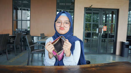 Asian woman sad to see an empty wallet