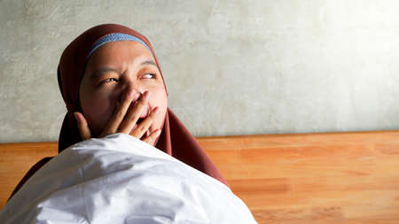 Asian girl wakes up from sleepの写真素材