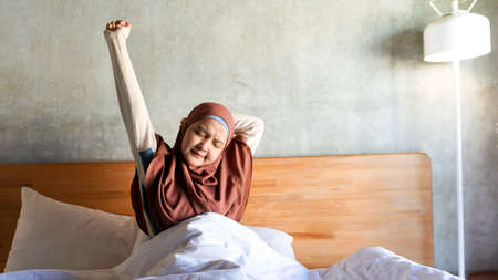 Asian girl wakes up from sleepの写真素材