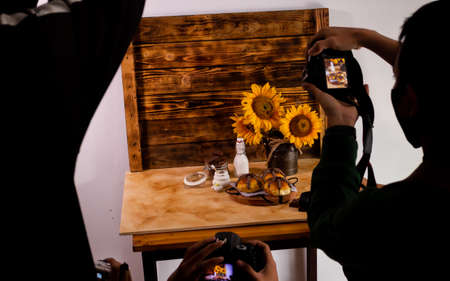Behind the scene people are photographing foodの写真素材