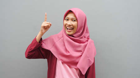 Asian muslim woman wearing hijab with thinking expression. Looking for solution of a problemの写真素材