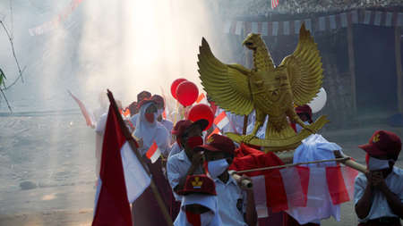 9 August 2020, Yogyakarta, Indonesia: indonesian student carnaval for Indonesia independence day, Garuda bird and flag propertiesのeditorial素材