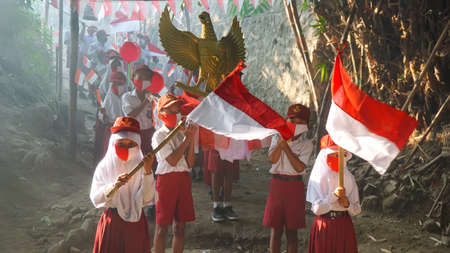 9 August 2020, Yogyakarta, Indonesia: indonesian student carnaval for Indonesia independence day, Garuda bird and flag propertiesのeditorial素材
