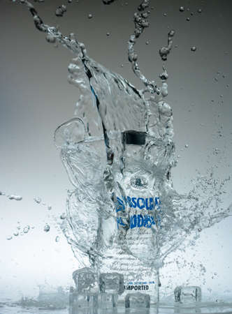 12 Augsut 2020, Yogyakarta, Indonesia: Vodka bottle water splash with iced cube propertiesのeditorial素材
