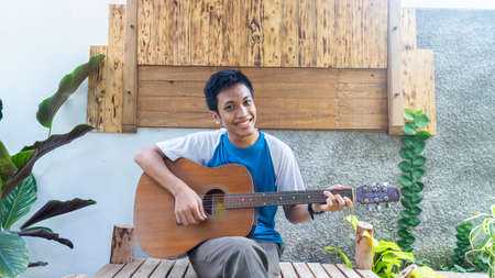 a man playing guitar in parkの写真素材