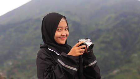 The woman wearing the hijab vacation at Spot New Selo with the background of Mount Merbabu