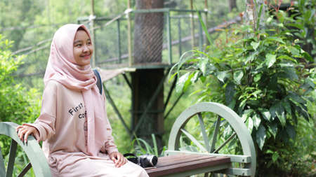 Hijab woman vacation wearing a pink dress and hijab at Kalikuning, Yogyakartaの写真素材