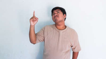 ASIAN FAT MAN WHO ARE THINKING OF SOMETHING AND GET IDEAS