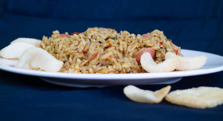 Nasi goreng or fried rice with sausage and crackers or kerupukの写真素材
