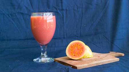 Guava juice with guava fruit with blue backgroundの写真素材