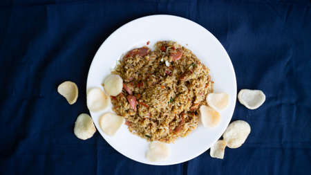 Nasi goreng or fried rice with sausage and crackers or kerupukの写真素材
