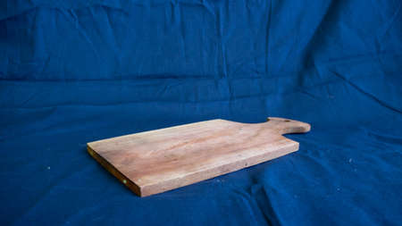 Display of traditional wooden cutting board talenan brown with square rectangle round shape with one hole on top side. Use to cut ingredient foodの写真素材