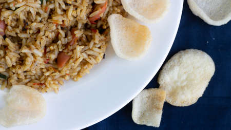Nasi goreng or fried rice with sausage and crackers or kerupukの写真素材