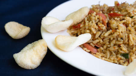 Nasi goreng or fried rice with sausage and crackers or kerupukの写真素材