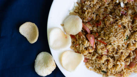 Nasi goreng or fried rice with sausage and crackers or kerupukの写真素材