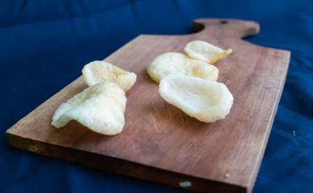 Crackers or kerupuk on top Wooden base of a trayの写真素材