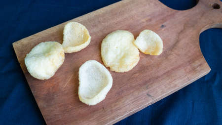 Crackers or kerupuk on top Wooden base of a trayの写真素材
