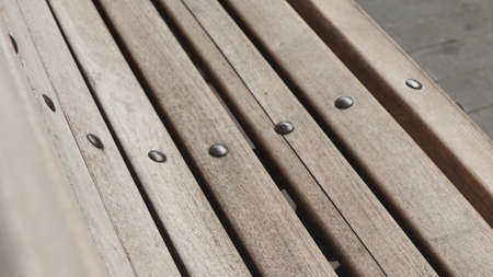 Selective and partial part image a retro style of garden bench with iron legs and armchair, photographed from above at close rangeの写真素材