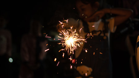 Blurry of children having fun playing fireworksの写真素材