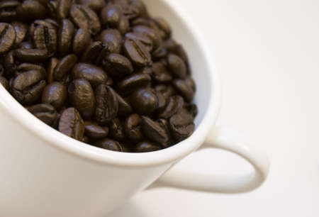 Coffee beans and white cup
