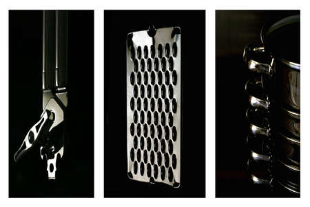 silver cooking utensils silhouetted on black backgroundの写真素材