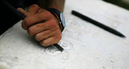 Stone mason at work carvingの写真素材