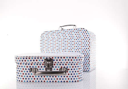 Multi coloured gift cases on white background with copy space