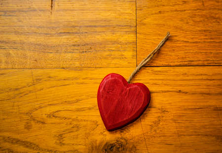 Red Wooden heart on hardwood floor boardsの写真素材