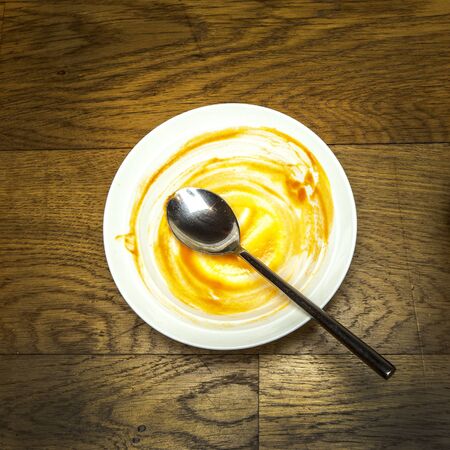 Vintage wooden kitchen table with empty soup bowl