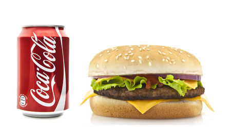 SWINDON, UK - FEBRUARY 22, 2014: Coca-Cola and Cheeseburger on a white backgroundのeditorial素材