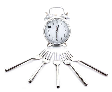 Alarm Clock - Time for Lunch With Forks on a White Backgroundの写真素材