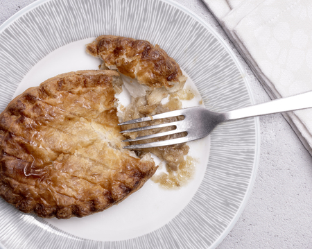 Overhead View of a Chicken pie on a plate with fork and napkin.の写真素材