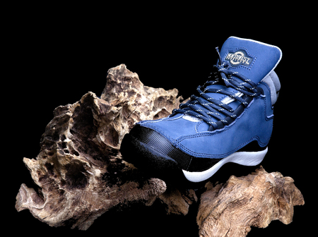 SWINDON, UK - MAY 13, 2018: Northwest Territory Boot on an old piece of tree with a dark backgroundのeditorial素材