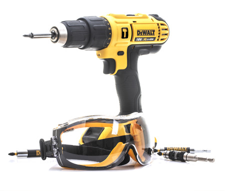 SWINDON, UK - AUGUST 18, 2018: Pair of DeWalt Safety Glasses and cordless drill on a White...