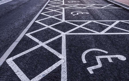 Disabled parking spaces painted on a tarmac roadの写真素材